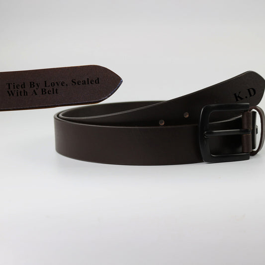 Brown leather belt with engraved text on a light gray background