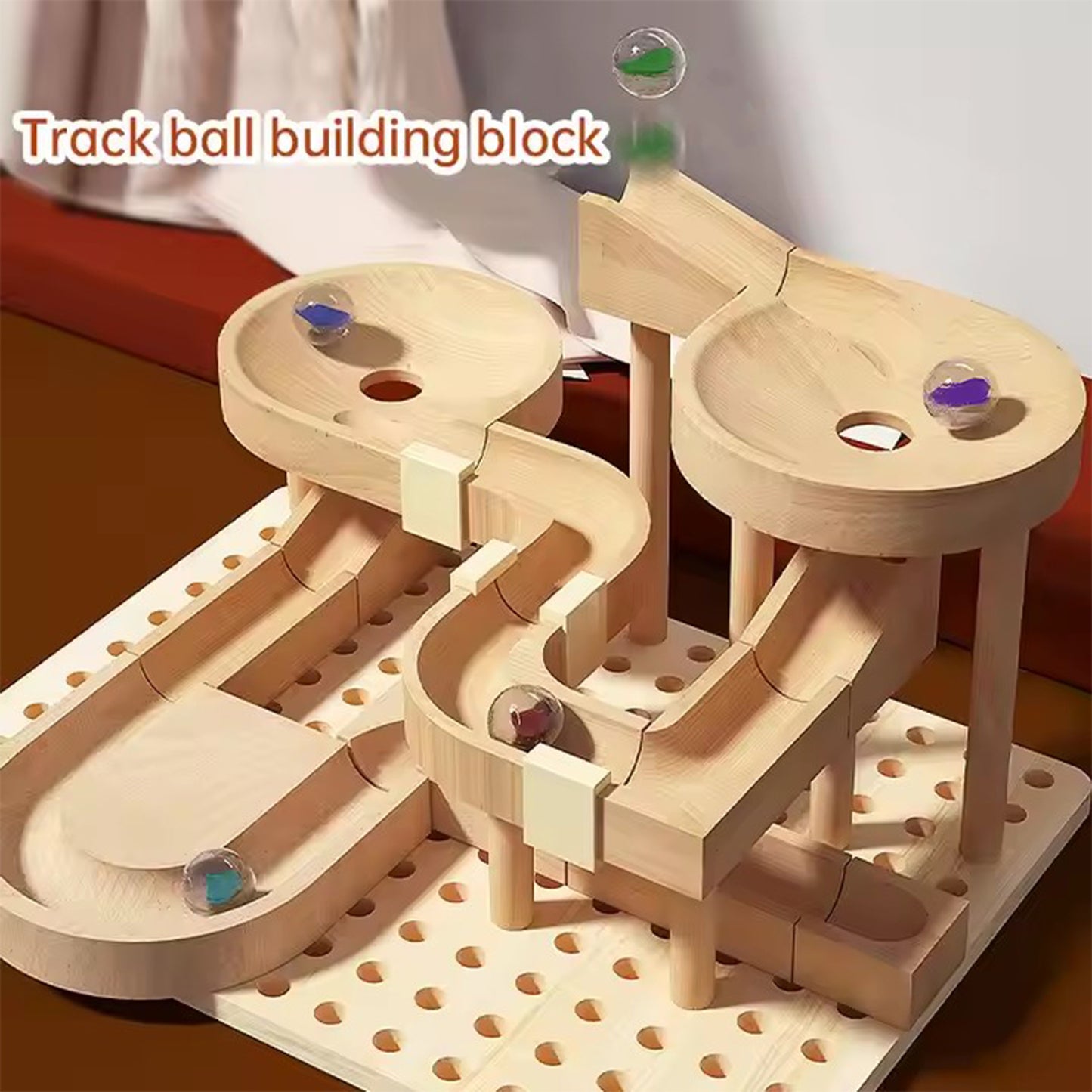 Wooden track ball building block set with marbles on a white background