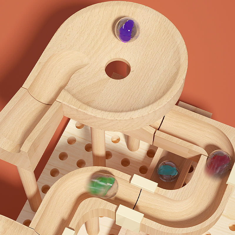 Wooden marble run toy with colorful marbles on a brown background