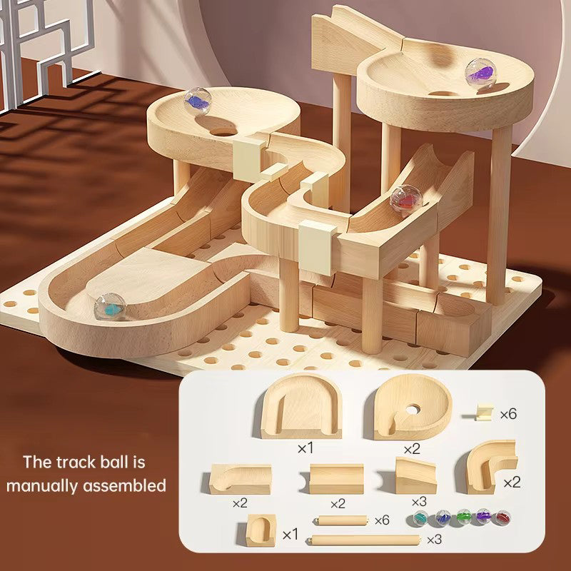 Wooden marble run toy set with components on a brown surface