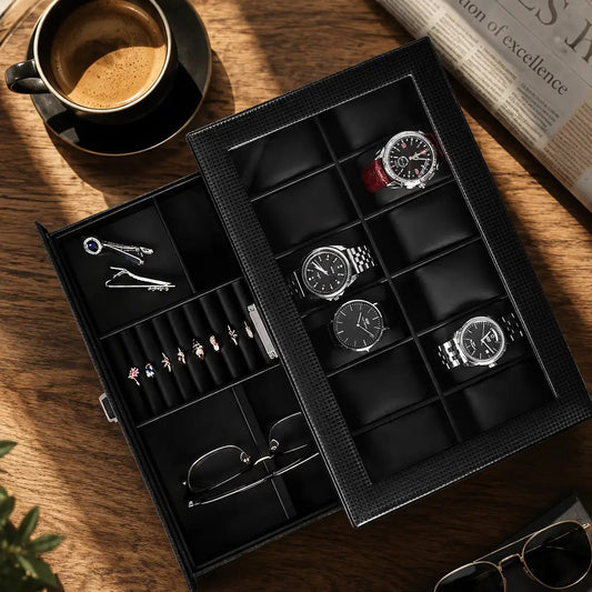 Luxury carbon fiber watch and jewelry organizer styled on a wooden coffee table beside espresso, newspaper, sunglasses, and modern everyday carry accessories in warm natural morning sunlight.
