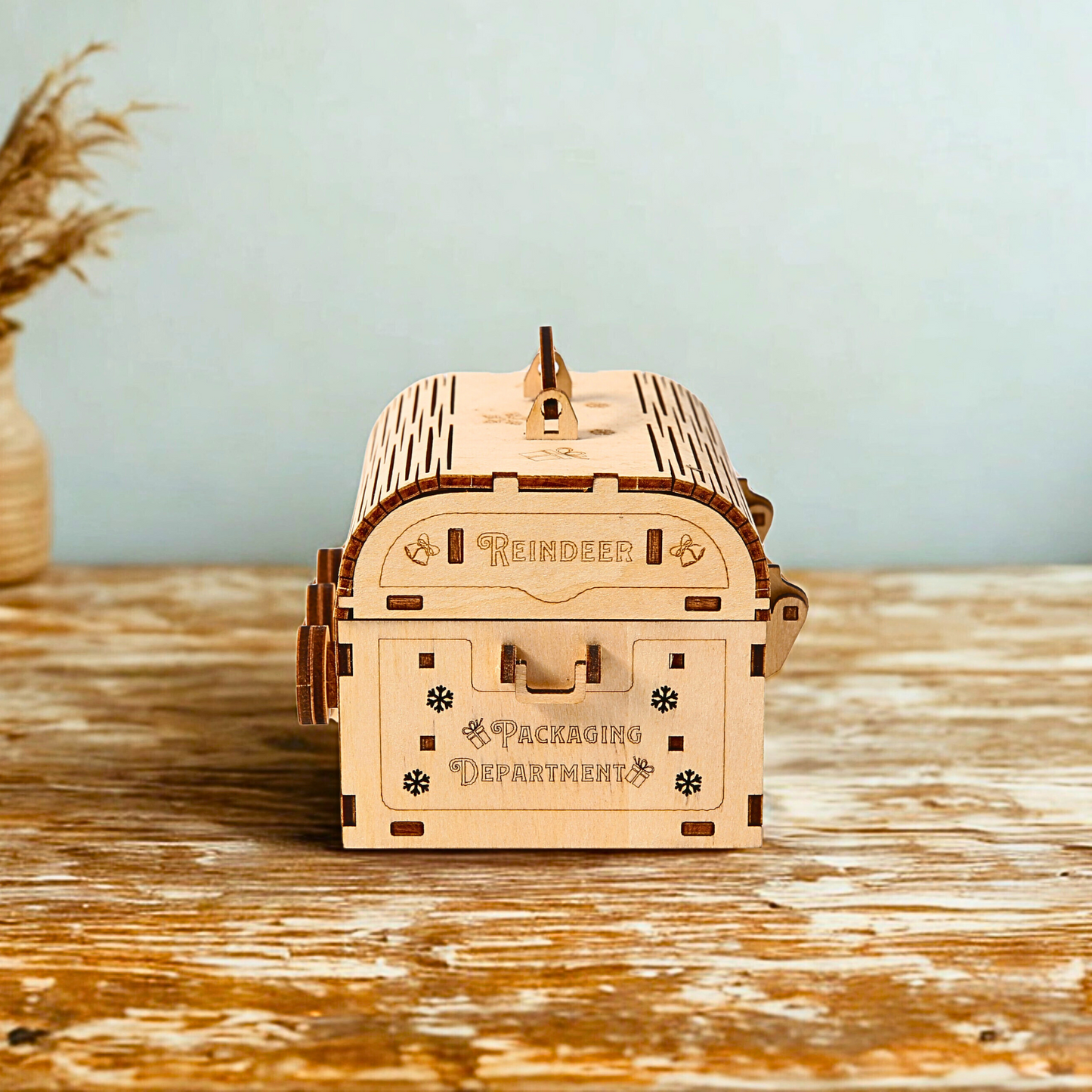 Wooden coding box puzzle model on a wooden surface with a light blue background