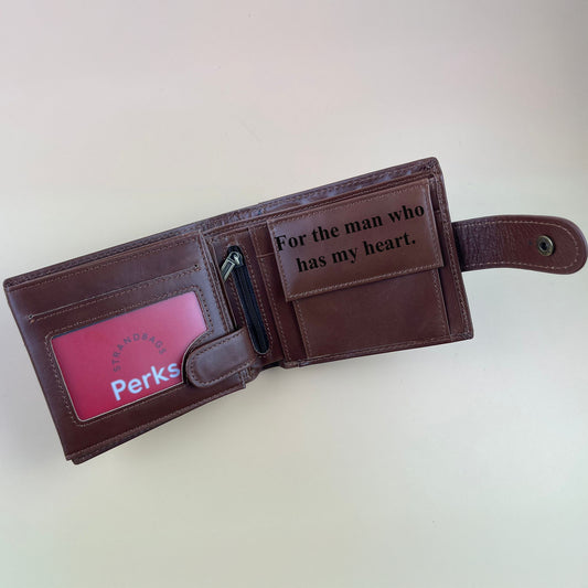 Brown leather wallet with a message and spacious compartments to keep money on a light background