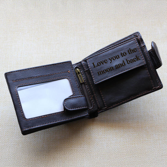 Brown leather wallet with 'Love you to the moon and back' engraving, placed on a beige background