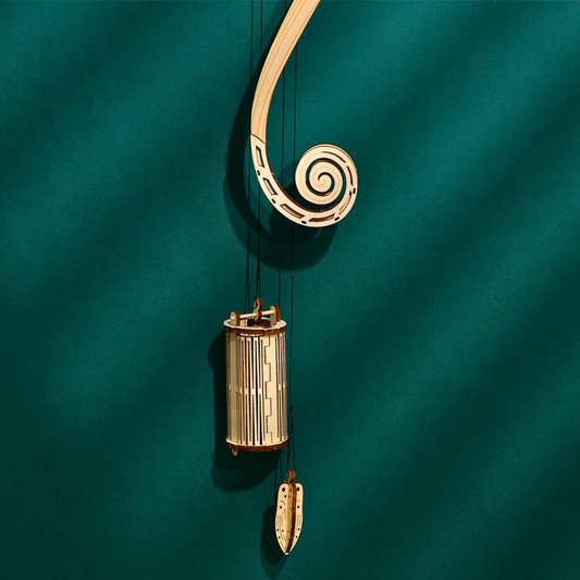 Decorative wooden ornament of a wall clock puzzle with a spiral design on a teal background