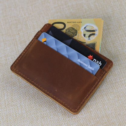 Interior view of a premium leather wallet showing tiered card slots and a secure zippered coin pocket with durable contrast stitching.