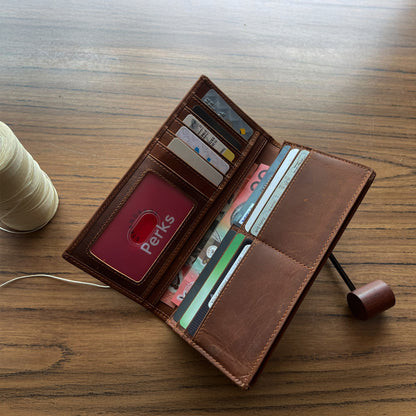 Handcrafted light brown leather trifold wallet for men, featuring high-capacity organized storage and durable hardware, presented on a rustic burlap surface.