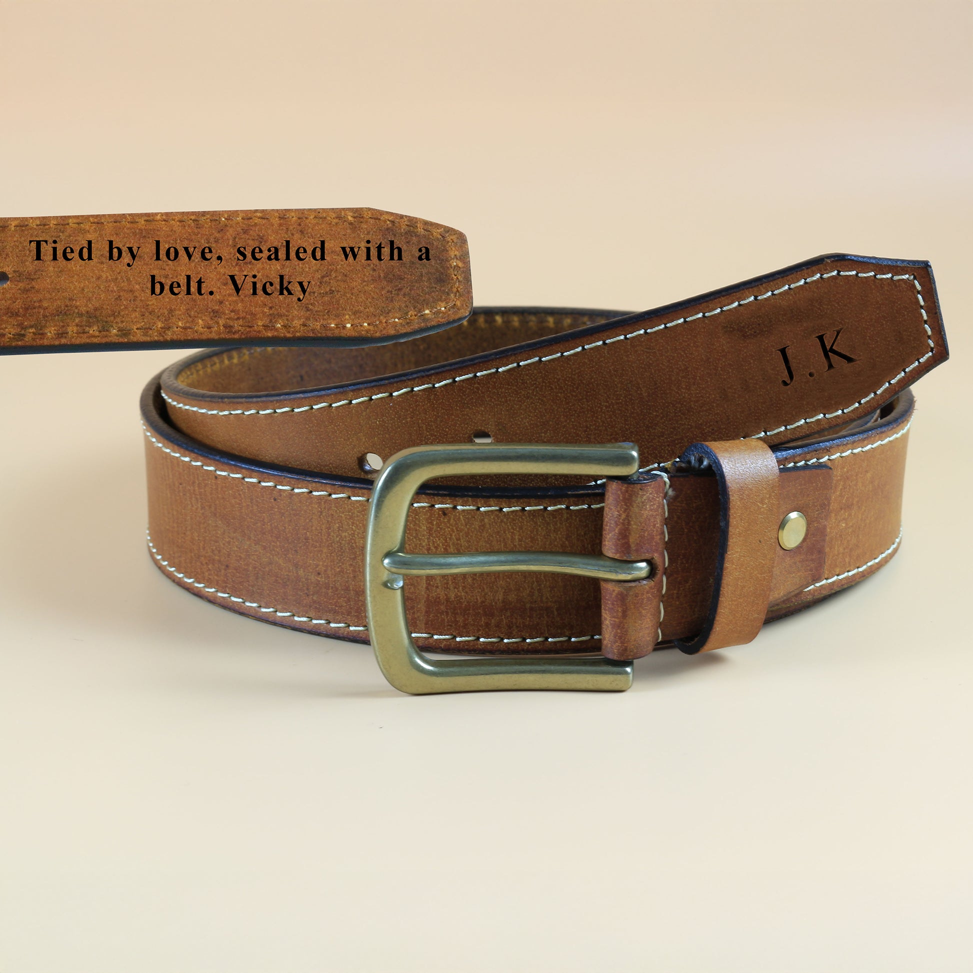 Men's Brown leather belt with gold buckle on a beige background