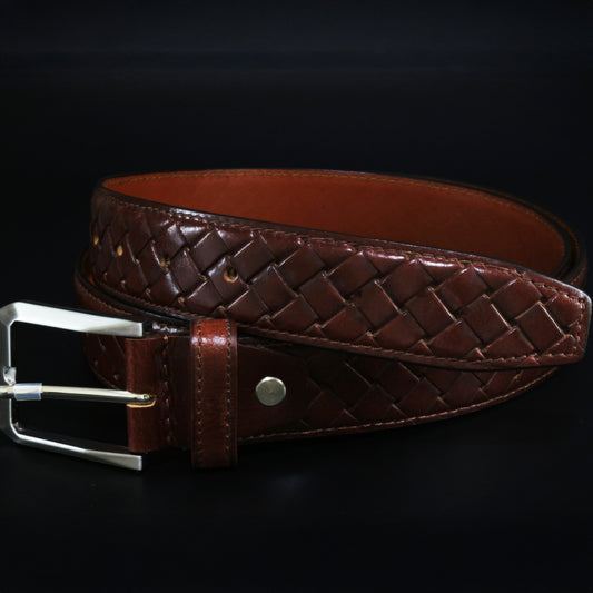 Brown woven leather belt with a silver buckle on a black background