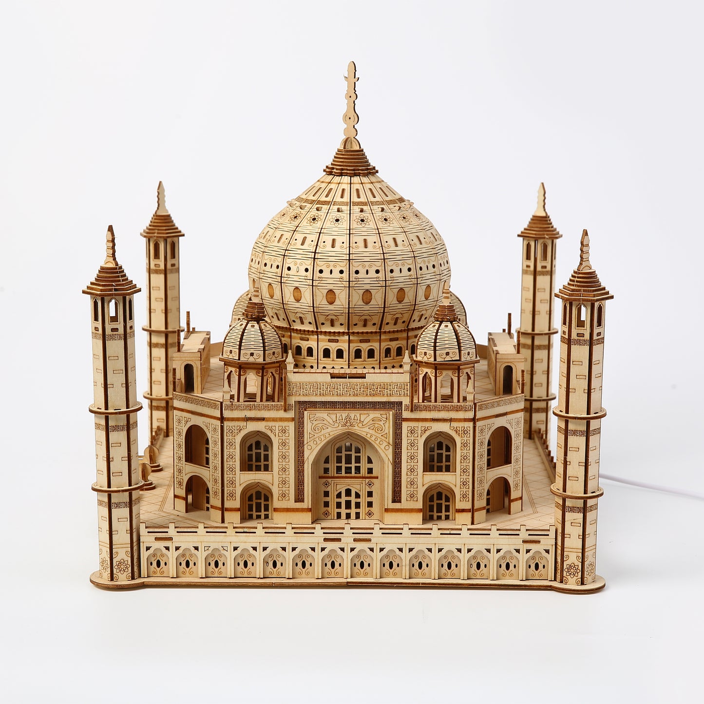 Wooden model of the Taj Mahal on a white background