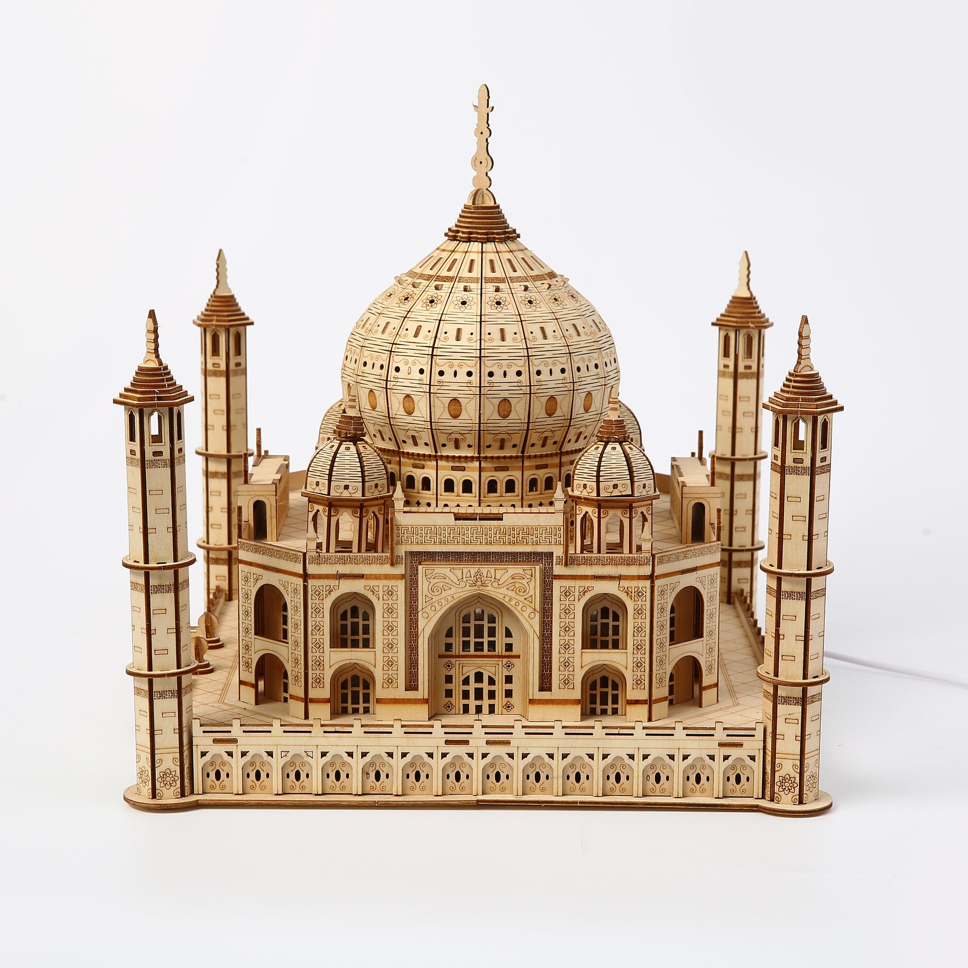 Wooden model of the Taj Mahal on a white background