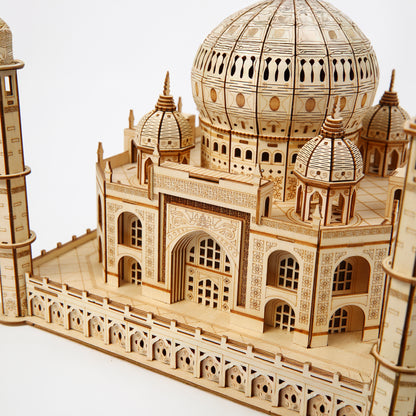 Wooden model of the Taj Mahal on a white background