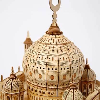 Wooden model of a architectural structure with intricate details on a white background