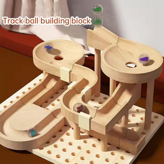 Wooden track ball building block set with marbles on a white background