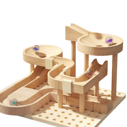 Wooden marble run toy with multiple levels and colorful marbles on a white background