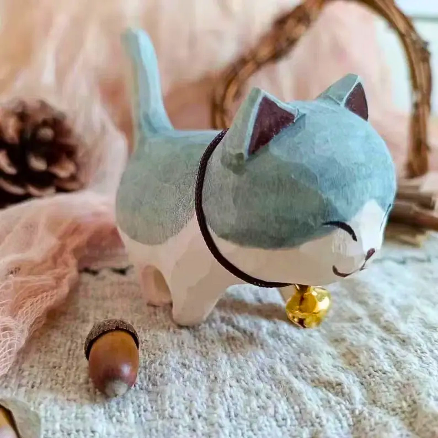 Hand carved wooden cat with a bell, makes the desk look cuter.
