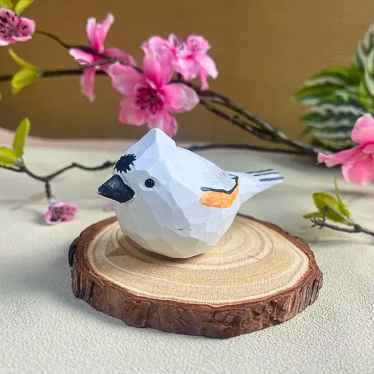 White bird figurine on a wooden base, used as an elegant decoration piece.