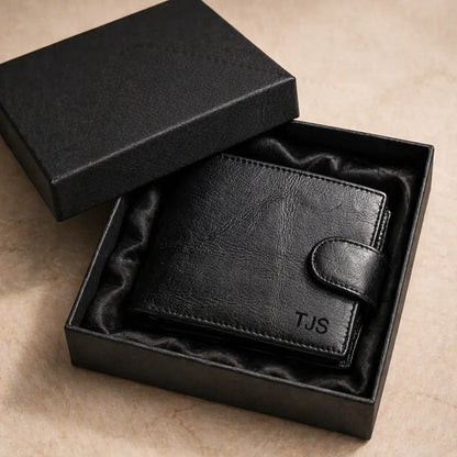 Leather Bifold Wallet full-grain black leather, snap-tab closure, hand-stitched edges, monogram engraving, RFID-blocking secure storage design.
