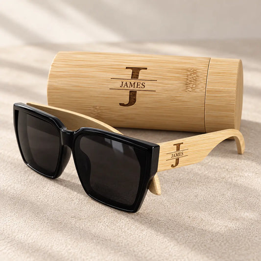Personalised wooden sunglasses and case engraved with JAMES monogram, featuring black lenses and natural bamboo arms