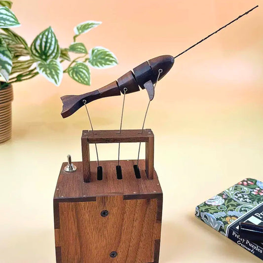 Wooden fish-shaped marionette on a stand, handmade mechanical ornament, for home decor or for kids to play with.