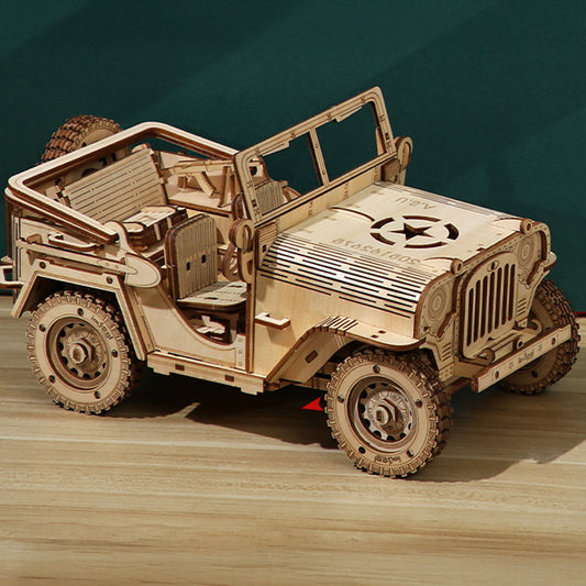 Wooden model of a Jeep on a wooden surface with a dark green background