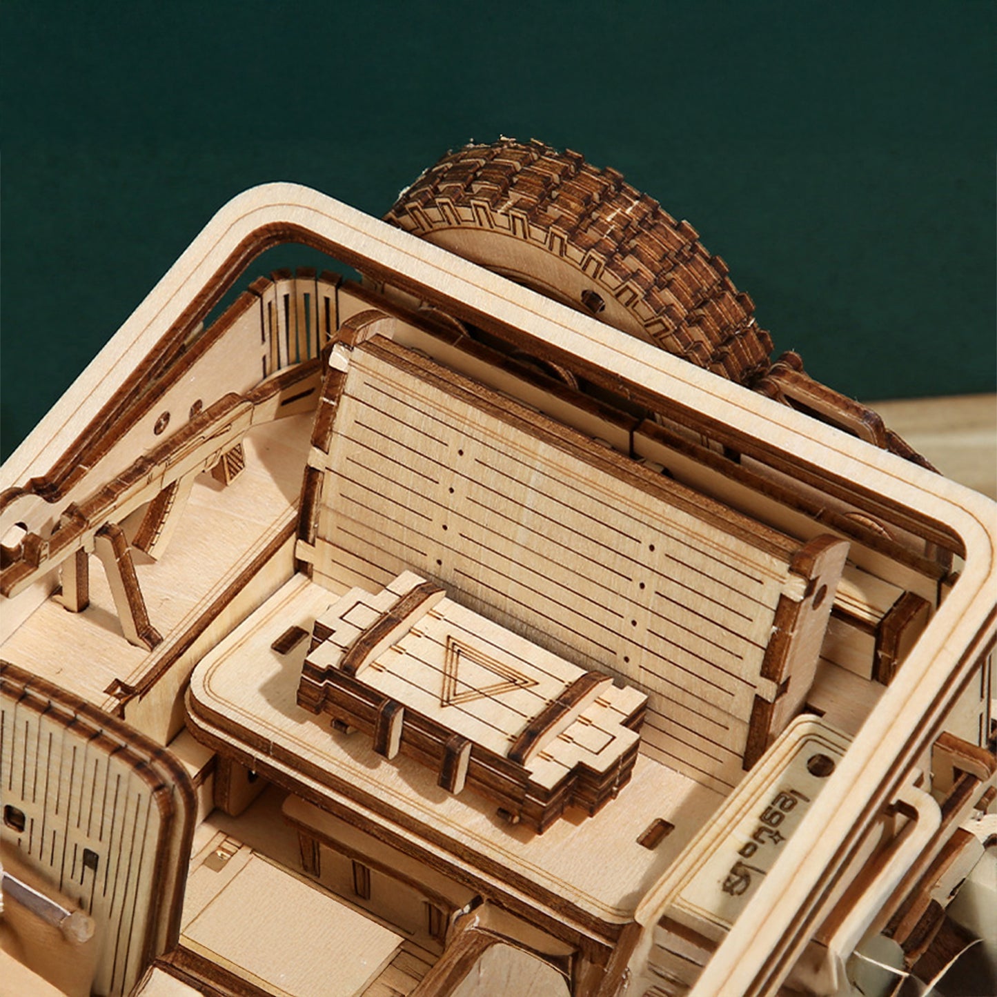 Close-up of a wooden model ship with detailed architecture and deck.