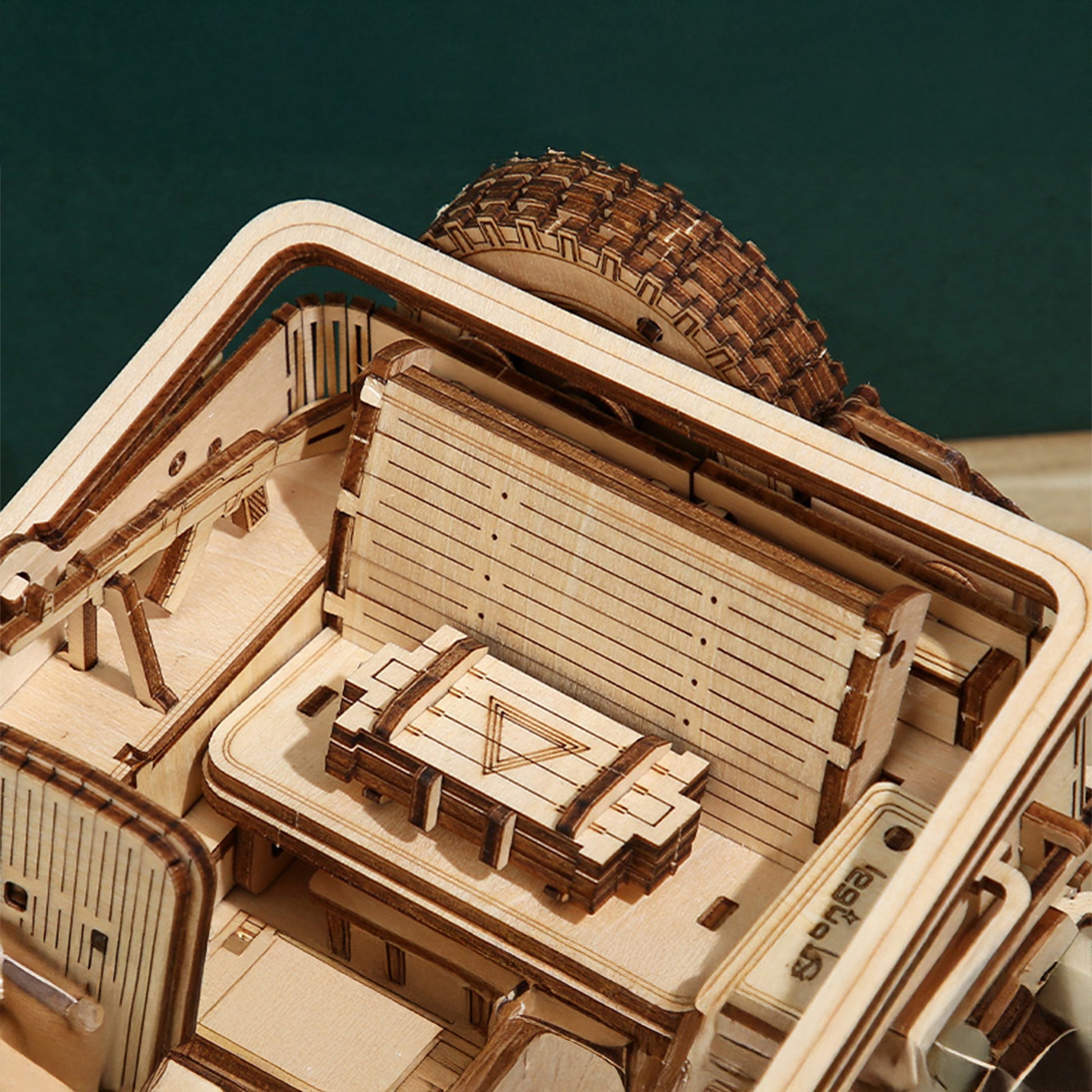 Close-up of a wooden model ship with detailed architecture and deck.
