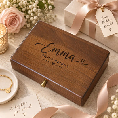 Personalised dark walnut wooden jewellery box engraved “Emma – SHINE BRIGHT,” styled with blush ribbon, birthday gift box, flowers and gold bracelet for her.