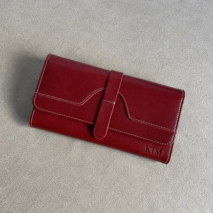 Personalised burgundy women’s wallet engraved with KIM featuring white stitching and front strap closure