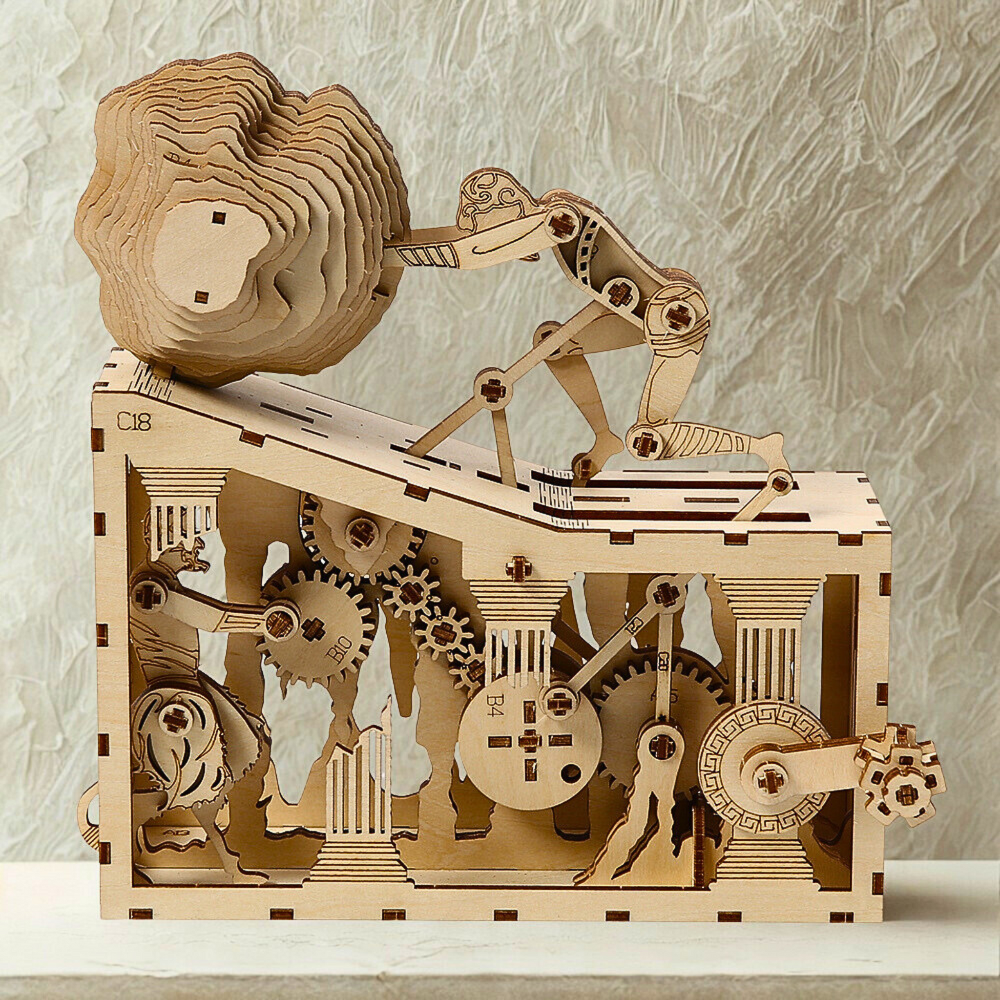 Wooden mechanical model of ancient  myth puzzle with gears on a textured surface
