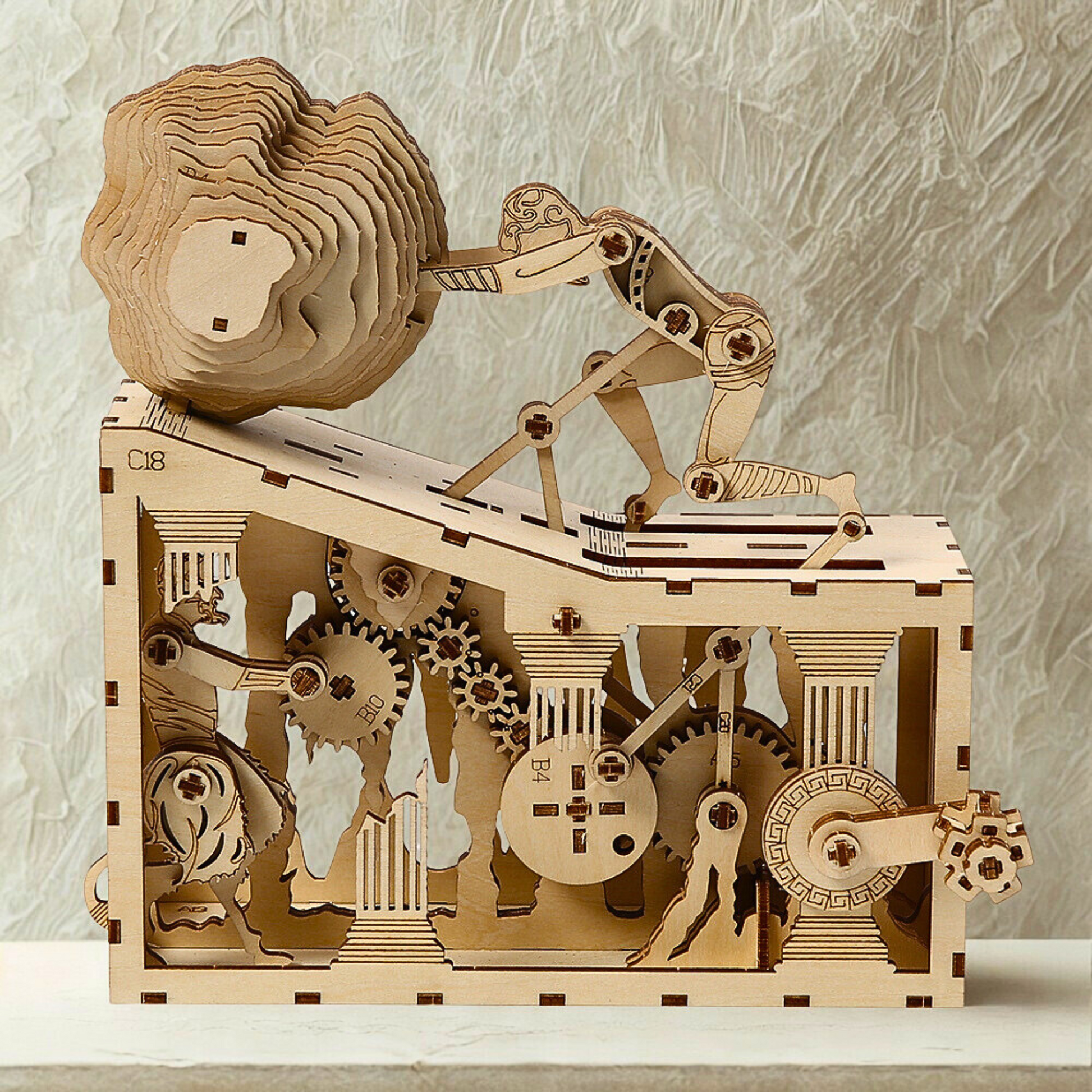Wooden mechanical model of ancient  myth puzzle with gears on a textured surface