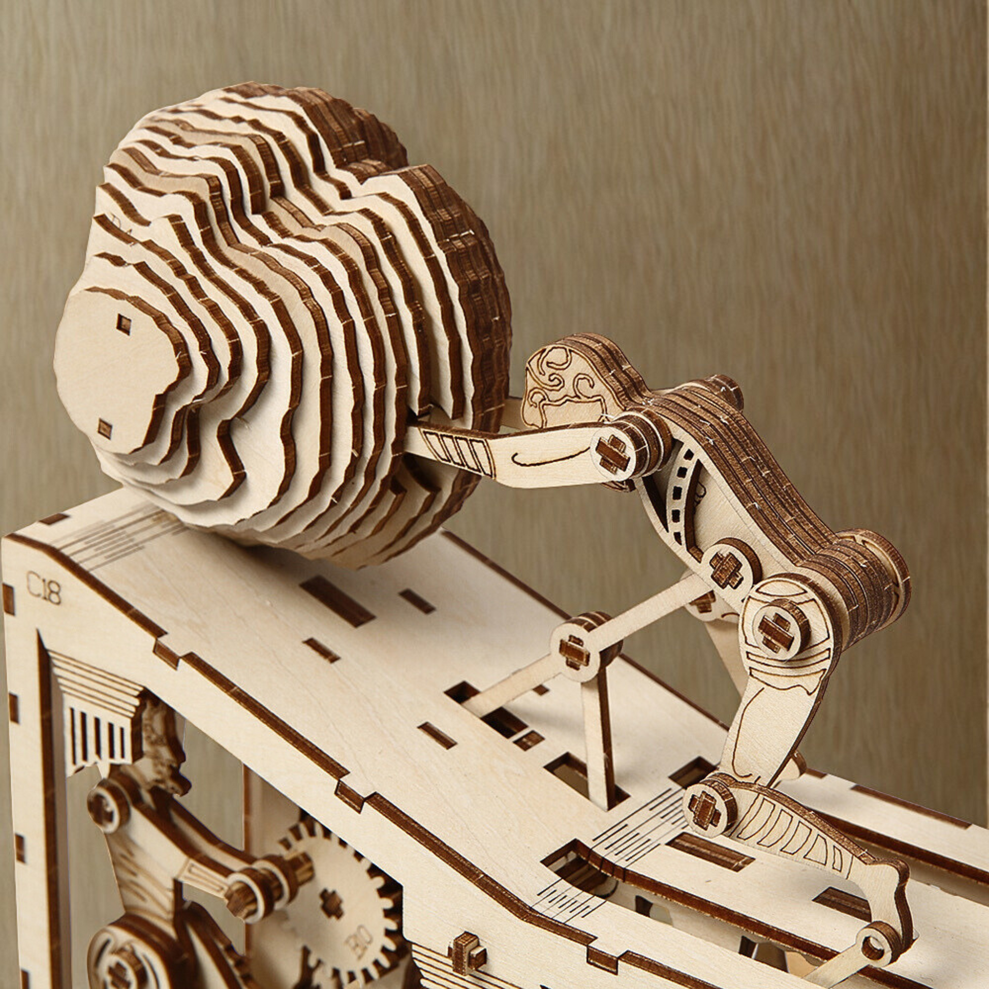 Wooden mechanical puzzle of a man and a ball on a wooden base