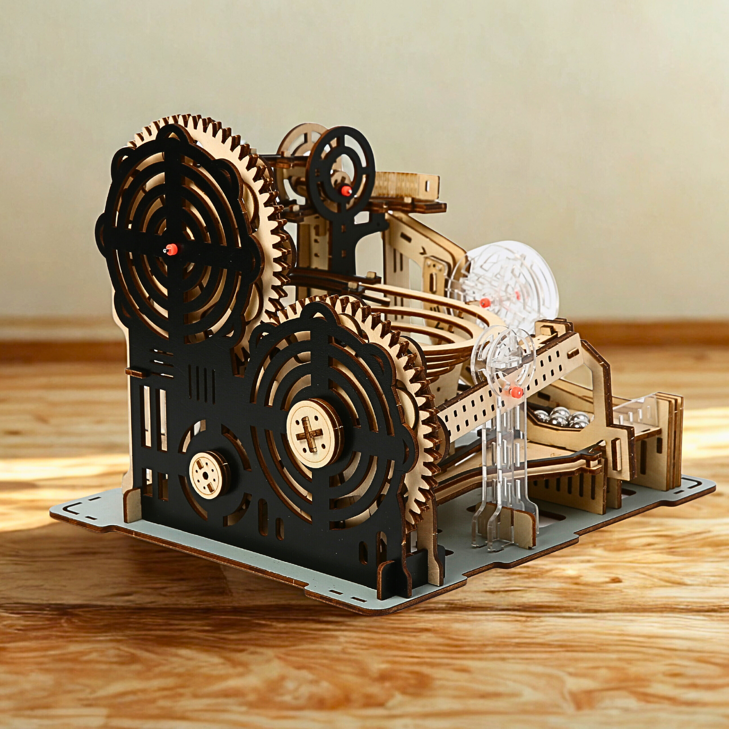 Wooden marble run puzzle model with gears on a wooden surface