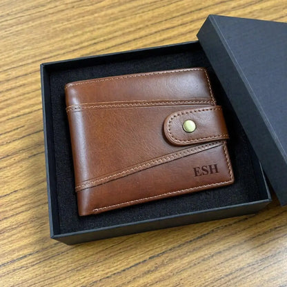 Custom engraved men's brown leather wallet with initials, handcrafted bifold design with decorative stitching in a professional gift box.