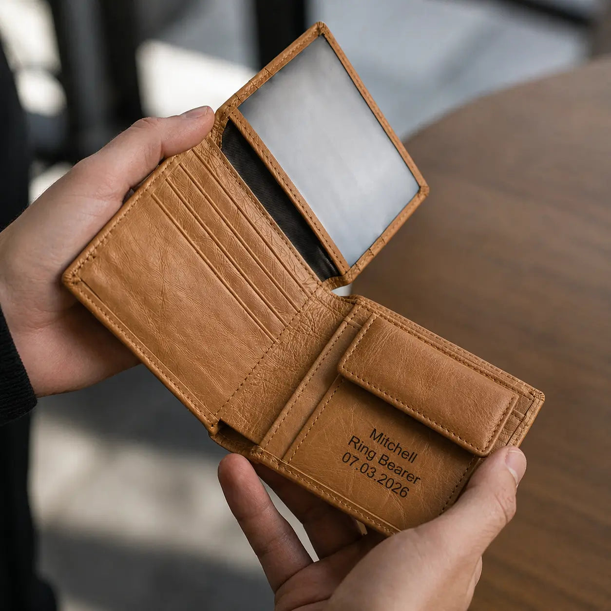 Men's light brown leather trifold wallet interior highlighting organized card slots, clear ID holder, and custom laser engraving for wedding party gifts.