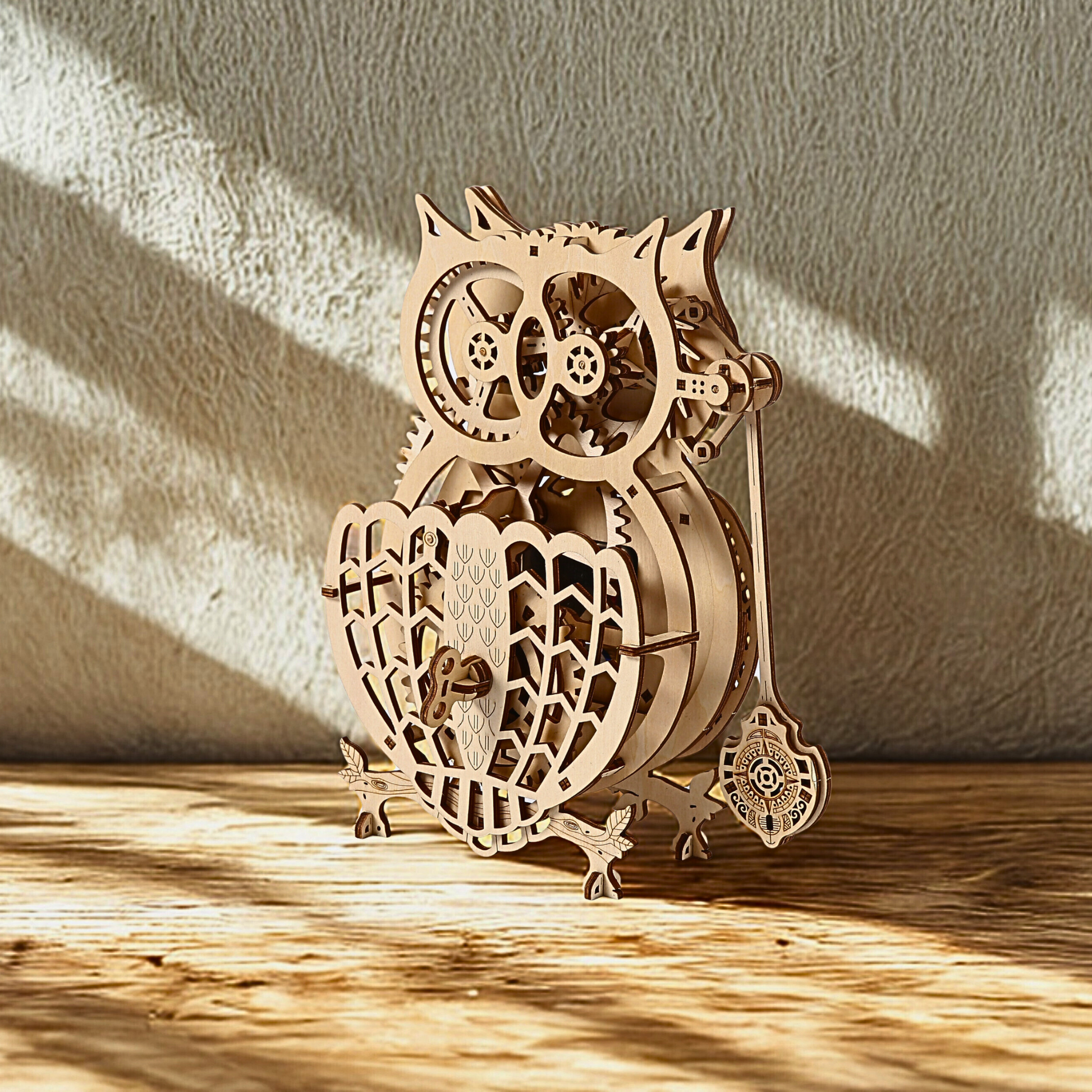 Wooden owl clock model with intricate design on a wooden surface