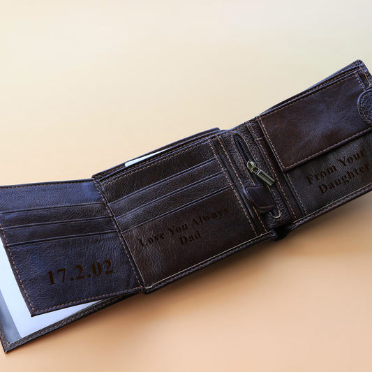 Brown leather wallet with engraved text on a beige background