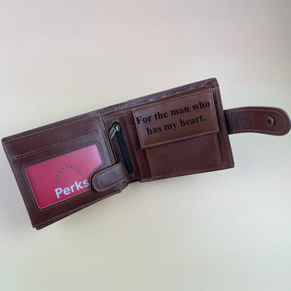 Brown leather wallet with a message and spacious compartments to keep money on a light background