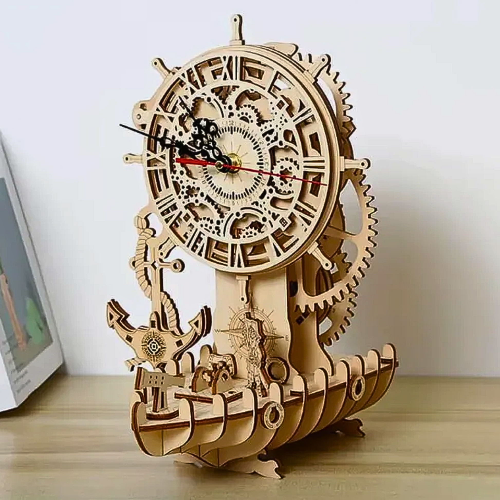 A 3D wooden model puzzle of a pirate boat featuring a clock on top, used as a decorative and functional piece.
