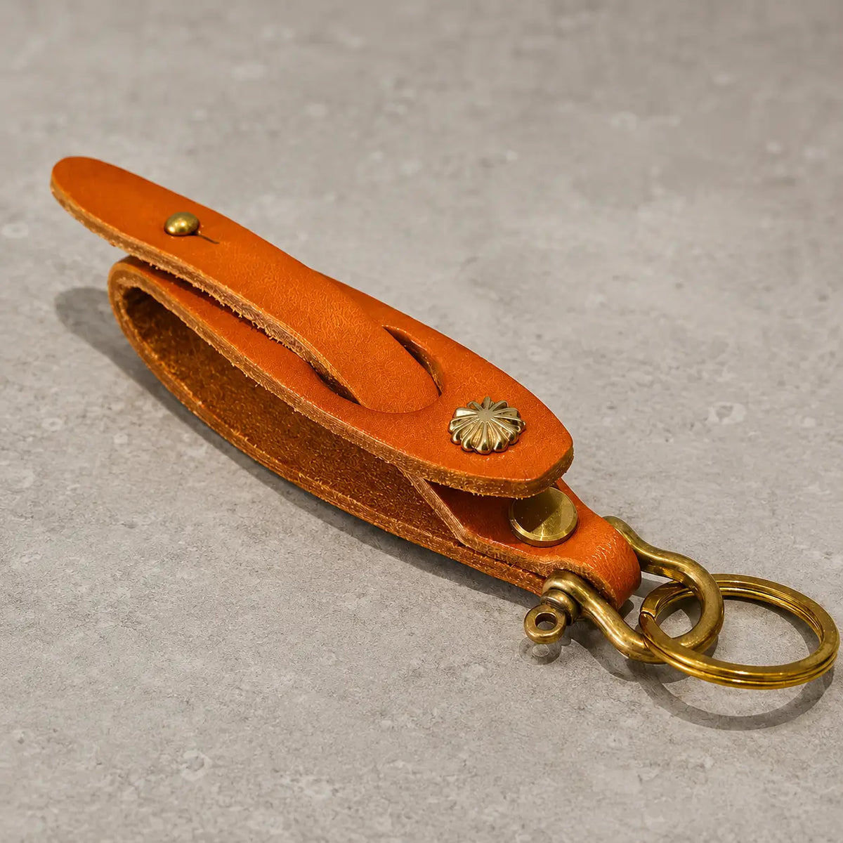 Orange and white leather key holders shown with product dimensions and antique brass key rings