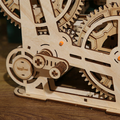 Close-up of a wooden marble run game puzzle with gears on a wooden surface