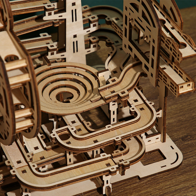 Wooden marble run game puzzle on a wooden surface