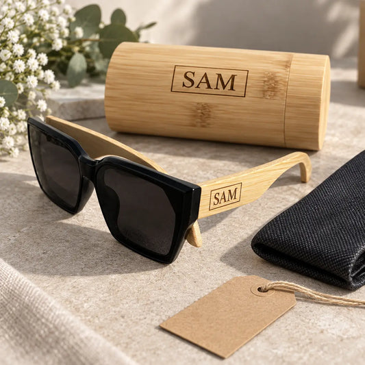 Personalised wooden sunglasses case engraved with SAM displayed beside black sunglasses and gift accessories