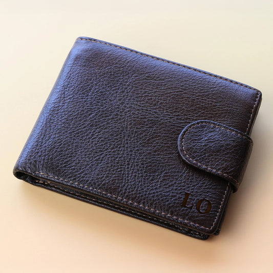 Blue leather wallet with 'LO' initials on a beige background