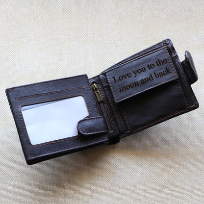 Brown leather wallet with 'Love you to the moon and back' engraving, placed on a beige background