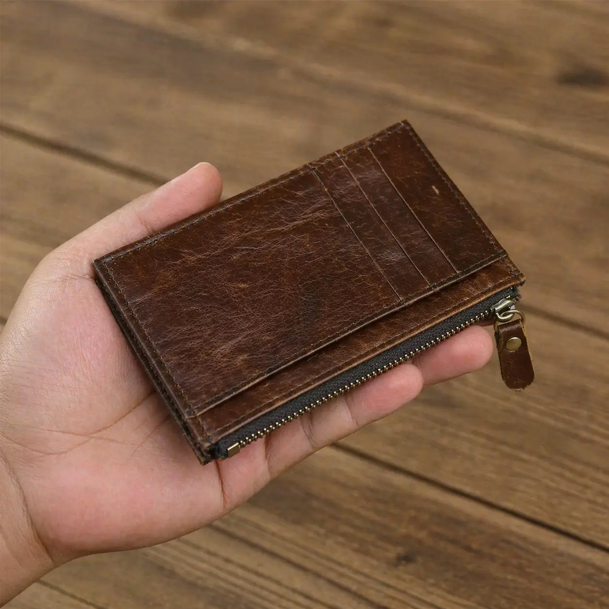 Personalized light brown leather wallet for men with a custom engraved sentimental message, shown in a professional lifestyle setting with organized credit cards.