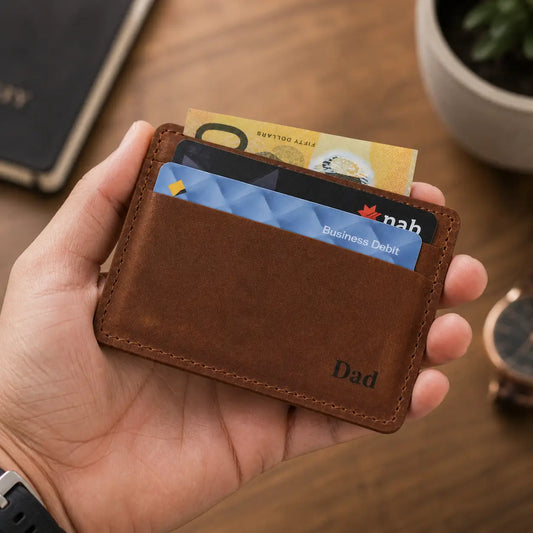 A person holding a handcrafted tan leather card wallet featuring tiered credit card slots and durable perimeter stitching against a lifestyle background.