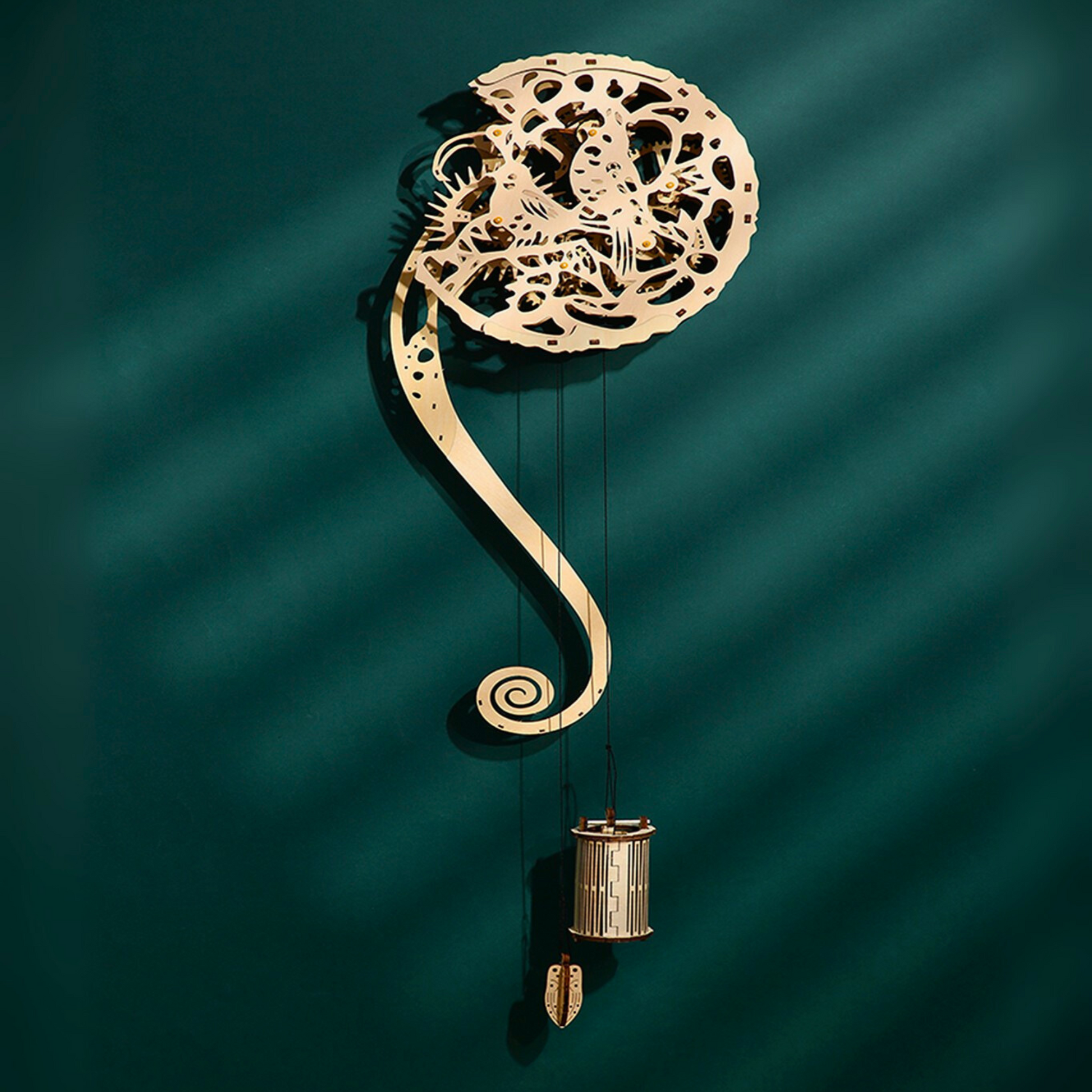 Decorative wall clock puzzle with intricate design on a teal background