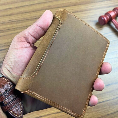 Premium handcrafted light brown leather wallet for men with a slim bifold design and durable peripheral stitching, held by a person wearing a matching leather watch strap.