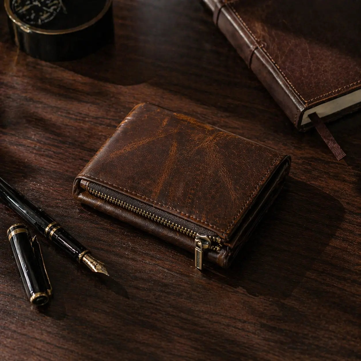 Leather Zipper Wallet in distressed dark mocha full-grain leather, featuring a robust brass zip and technical hand-stitching.